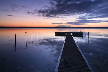Wooden Pier on Calm Lake at Sunrise