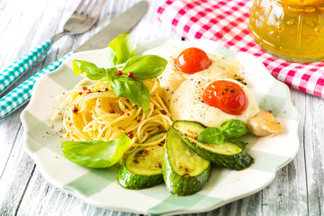 Italian lunch: chicken with mozzarella ,spaghetti and zucchini