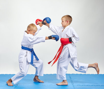 Paired exercise of karate are training athletes with overlays on his hands