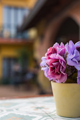 Artificial flower in pot on the table. Selective Focus.