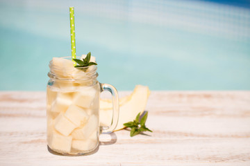 Melon juice in the glass on the wooden table