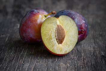 ripe plum on a wooden background