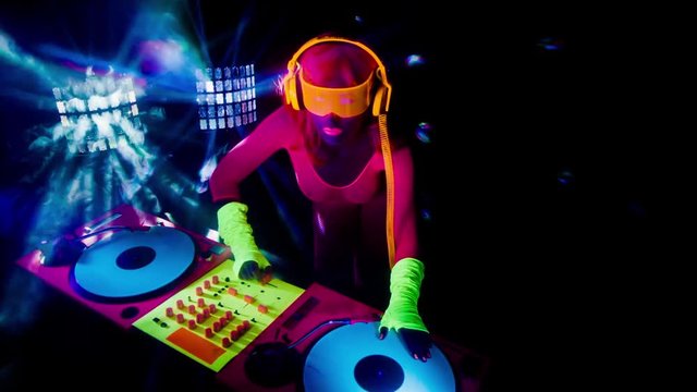 sexy DJ mixes in UV fluorescent costume