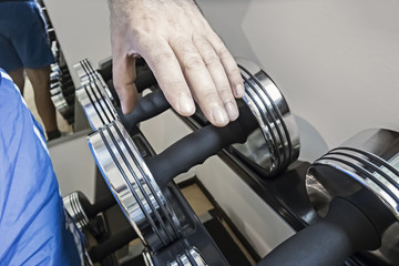 Fototapeta premium grabbing a dumbbell