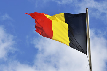 Flag of Belgium waving on the strong wind in Brussels