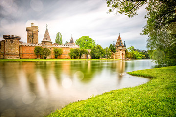 Obraz premium View on Franzensburg castle in Laxenburg town in Austria. Long exposure effect with glossy water and reflection.