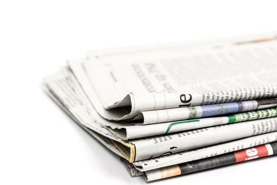 Stack of newspaper on white background. Image with clipping path.