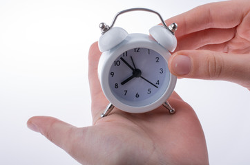 Alarm clock in hand
