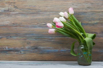 Colorful tulips flowers on wooden table. Top view with copy space