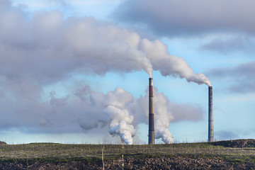 Obraz premium Dead Tundra on a background of smoking factory chimneys.