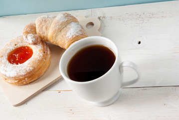 Sweet breakfast or snack. Freshly brewed black tea and fragrant homemade cakes on a rustic wooden table. Copy space
