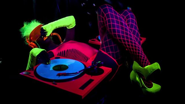 sexy DJ mixes in UV fluorescent costume