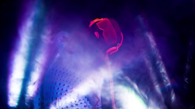 sexy DJ mixes in UV fluorescent costume