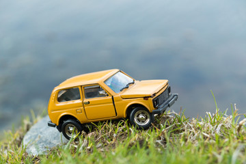 Toy SUV on River Shore