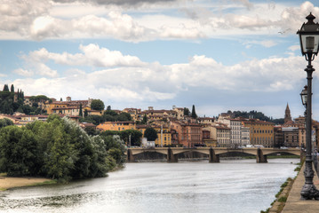 Several historical buildings next to the Arno river near the city of Florence, Italy
