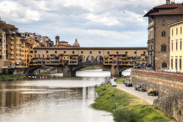 Several historical buildings and the Ponte Vecchio bridge next to the Arno river near the city of Florence, Italy
