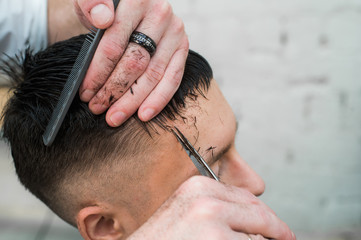 close up shot of man getting his hair cut