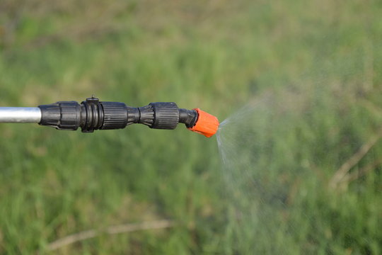 Spraying herbicide from the nozzle of the sprayer manual