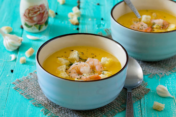 mashed vegetable soup and shrimp with garlic and green dill on a