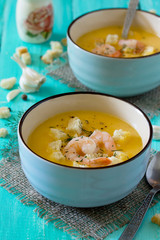 mashed vegetable soup and shrimp with garlic and green dill on a