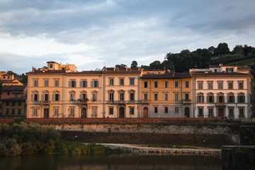 Several historical buildings next to the Arno river near the city of Florence, Italy
