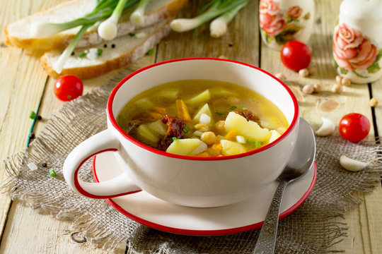 Vegetarian vegetable soup with chickpeas, potatoes and dried tom