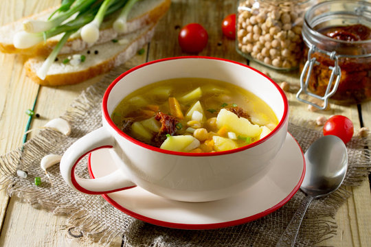 Vegetarian vegetable soup with chickpeas, potatoes and dried tom