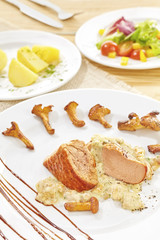 Roasted pork loin and chanterelles with creamy chanterelle sauce and vegetables.