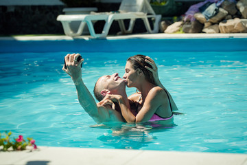 happy young couple at swimming pool