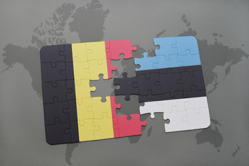 puzzle with the national flag of belgium and estonia on a world map background.
