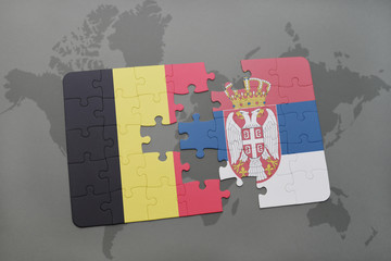 puzzle with the national flag of belgium and serbia on a world map background.