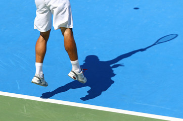 Tennis player serves the ball