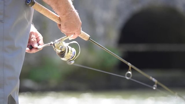 Closeup of fishing reel on rod