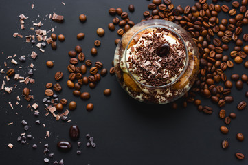 Tiramisu dessert in glass with chocolate and coffee beans