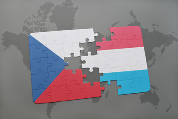 puzzle with the national flag of czech republic and luxembourg on a world map background.