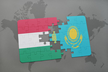 puzzle with the national flag of hungary and kazakhstan on a world map background.