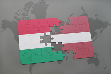 puzzle with the national flag of hungary and latvia on a world map background.