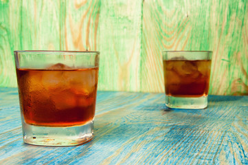 Glass of whiskey on a abstract wooden table