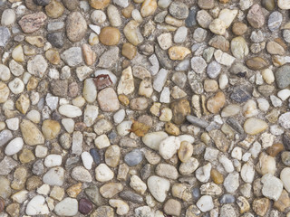 Abstract pebble stones in concrete background texture macro, selective focus