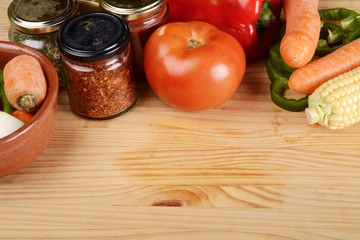 Vegetables and seasonings on wooden table.