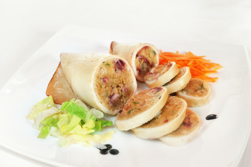Squid stuffed / Squid stuffed with prepared stuffing and baked. photographed in the studio on a white plate.