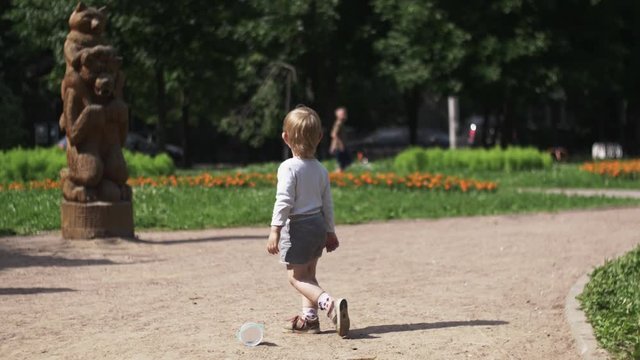 Little boy on playground. Sunny day. Family. Mother with baby on hands. Walking. Summer day