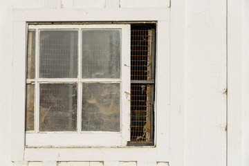 Closeup of a window in a white barn
