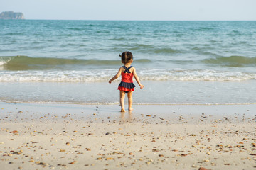 Adorable little girl at tropical white sand beach