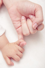Mom and Baby Hands Promise. friendship of generations, Soft focu
