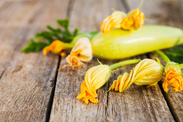 Fresh, organic flowers of zucchini on a wooden table,  rustic st