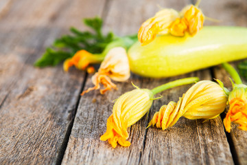 Fresh, organic flowers of zucchini on a wooden table,  rustic st