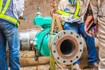 Construction worker welding underground valve gas pipeline