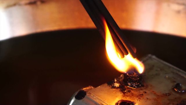 incense sticks burn up at candle