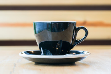 Cup of hot latte art coffee on wooden table

